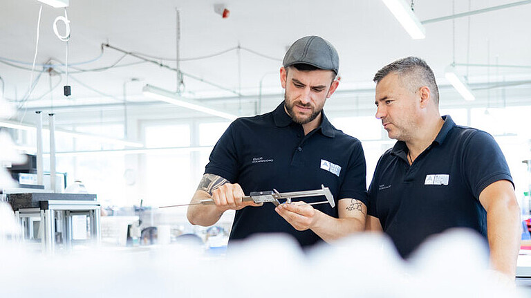 Quality pledge Henke Sass Wolf Employees of Henke Sass Wolf checking the quality of a product.
